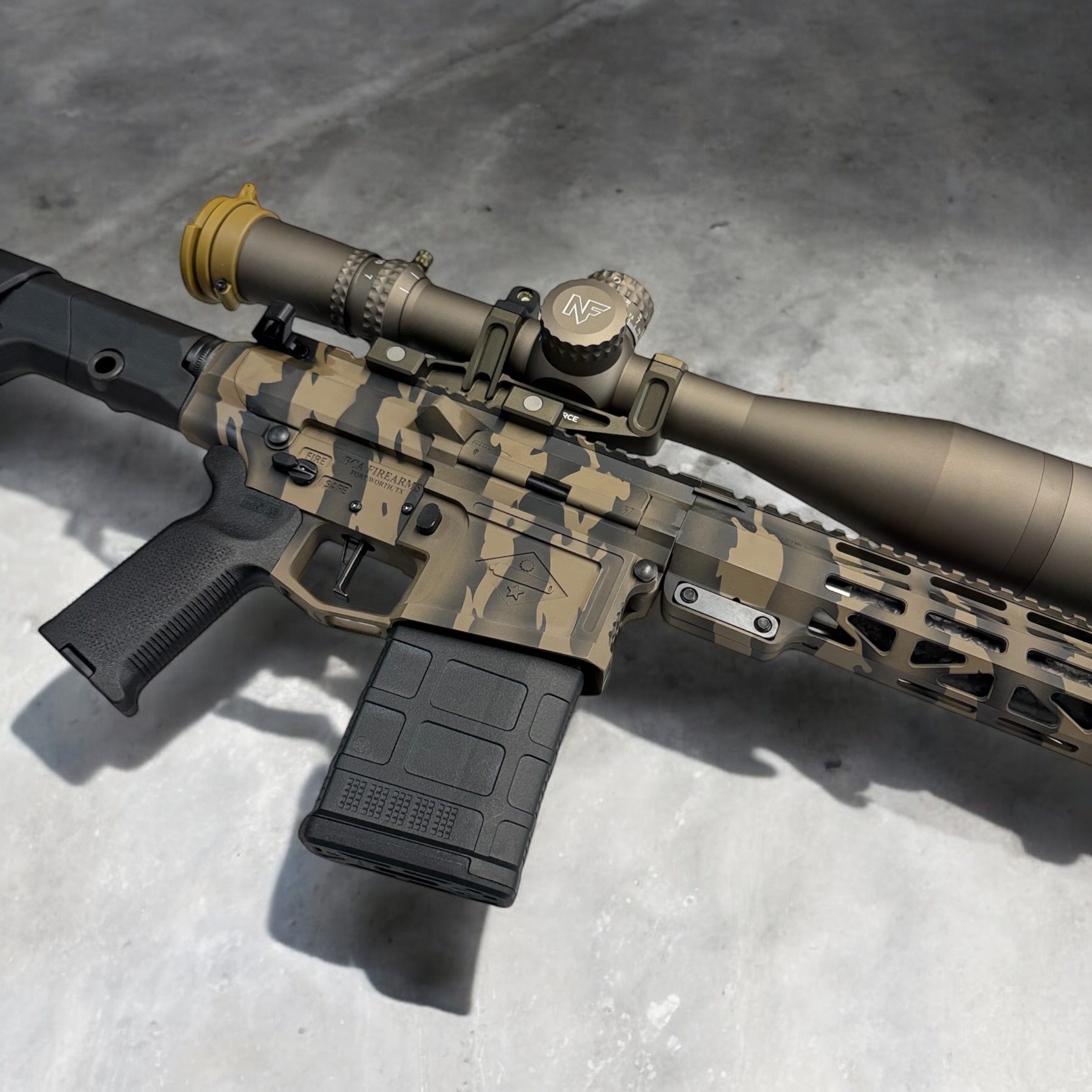 Close look at the BCA-10 Sentinel 6.5 Creedmoor rifle cerakote finished in Viper Tiger Stripe, shown with a Night Force scope. Precision, long range rifle, with a match grade carbon fiber barrel, and a 2.5 lb. CMC trigger.